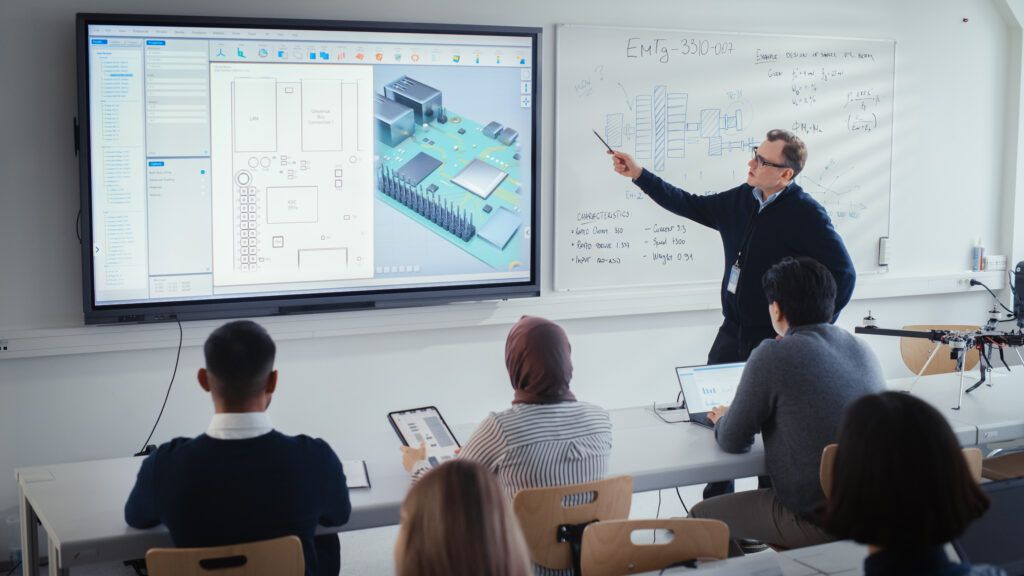 University professor giving a lecture using a smart board.